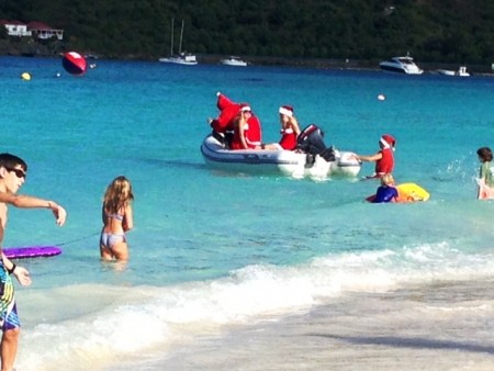 Everyone rushes to see Santa and his helpers arrive on St. Jean Beach on Christmas Day
